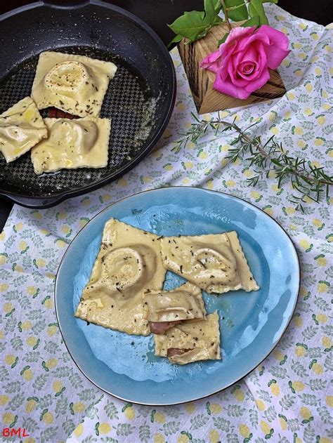 Some Kind Of Food On A Blue Plate Next To A Pink Rose And Potted Plant