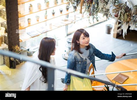 Women Going Up The Stairs Of A Café Stock Photo Alamy