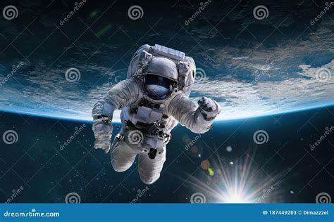 Astronaut In The Outer Space With Sun Over The Planet Earth Stock