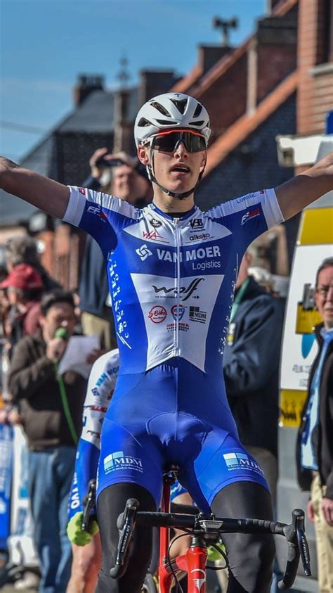 A Man Riding On The Back Of A Bike While Holding His Arms In The Air