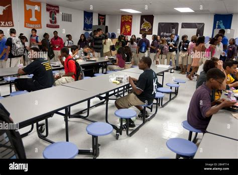 African American Male Student Sits Alone At Table During Lunch In