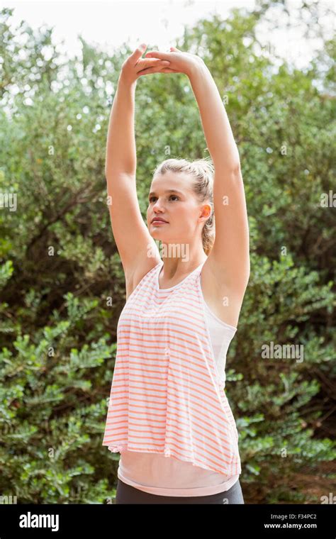 Focused Blonde Athlete Stretching Arms Stock Photo Alamy