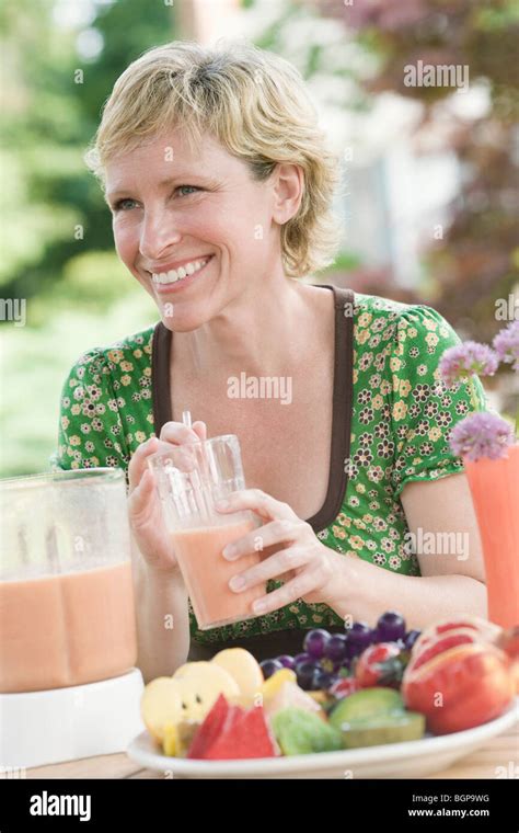 Mature Woman Having Breakfast And Smiling Stock Photo Alamy