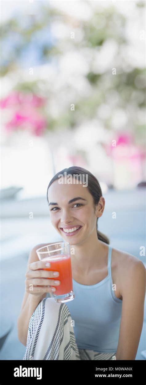 Portrait Smiling Confident Brunette Woman Drinking Juice Stock Photo Alamy