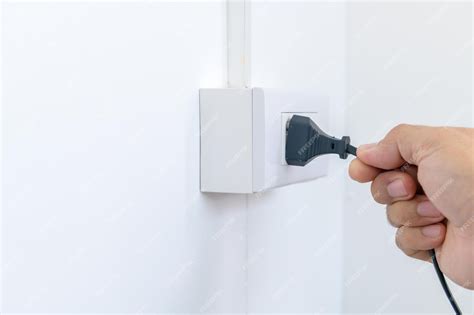 Premium Photo Hand Remove Electric Plug On Socket Electrical