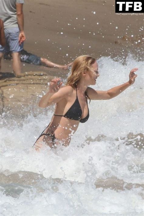 Heather Graham Slips Into A Black Bikini For A Beachside Frolic Next To A Mystery Man Photos