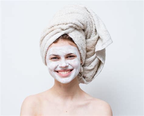 Happy Woman With White Mask On Her Face Naked Shoulders Clean Skin Towel On Head Stock Image