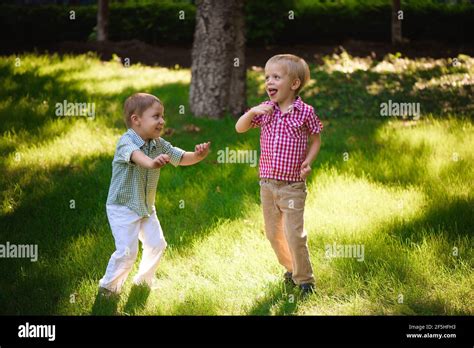Boys Brothers Hugging Brother Grass Hi Res Stock Photography And Images