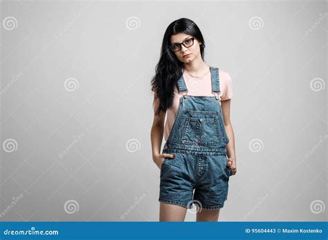 Portrait Of Smart Beautiful Brunette Girl In Eyeglasses With Natural Make Up On Grey Background