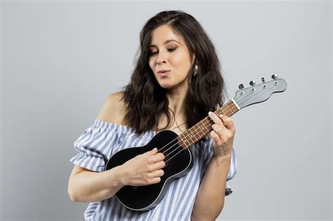 Premium Photo Cute Brunette Playing Ukulele