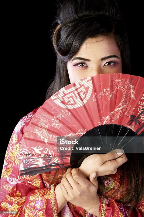 Modern Geisha With Fan Covering Lower Face Stock Photo Download Image