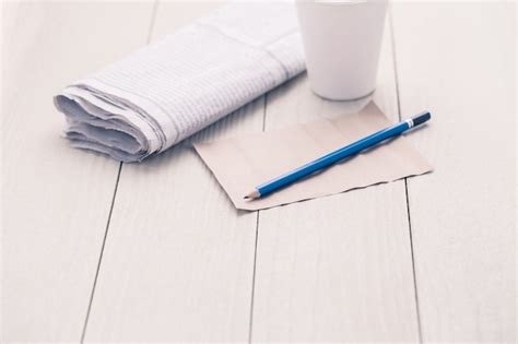 Premium Photo Paper And Pencil On Wooden Table