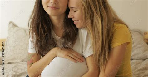 Pregnant Multiethnic Lesbian Couple Lies In Bed Are Very Happy That They Will Have A Baby At