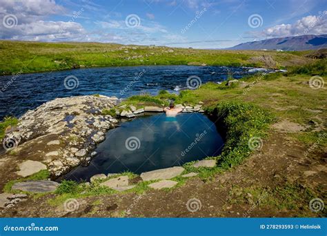 Man Relaxing And Bathing In Natural Geothermal Heated Hot Pool Hot Spring In Iceland In Summer