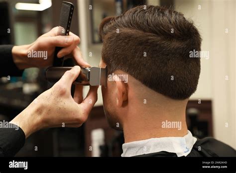 professional hairdresser making stylish haircut  salon  view