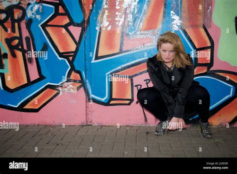 Beautiful Blonde Girl Against A Graffiti Covered Wall Wearing Black