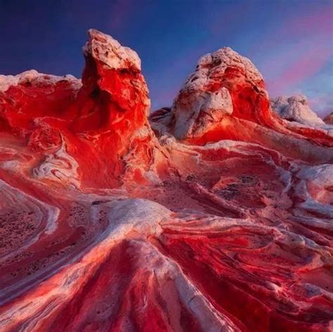 An Aerial View Of Red And White Mountains With Blue Sky In The Backgroud