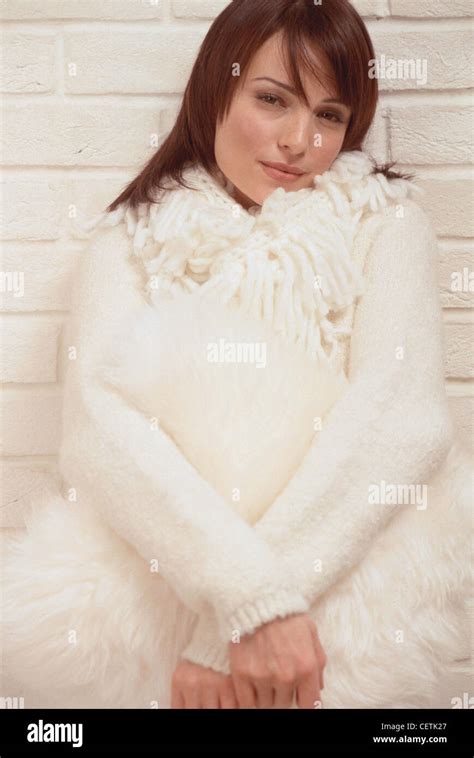 Female Shoulder Length Brunette Hair And Fringe Wearing Subtle Make Up White Jumper And White