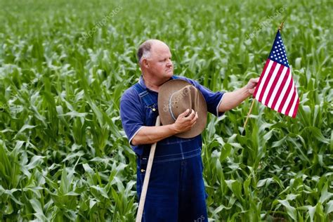 Old Farmer Holding The Us Flag — Stock Photo © Yobro10 41242585