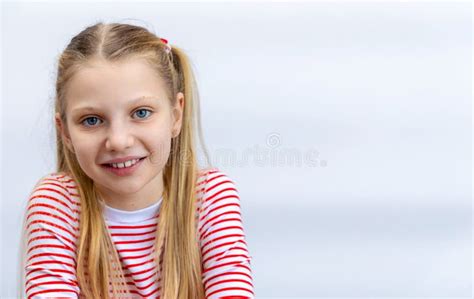 Smiling Girl In Striped Shirt With Pigtails A Blonde Girl With