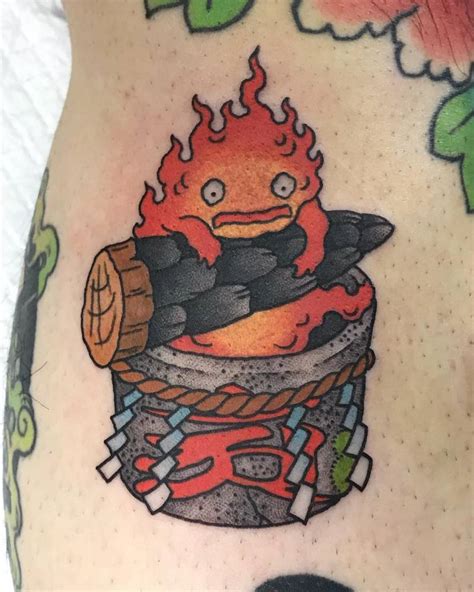 Calcifer Tattoo Located On The Calf Cartoon Style