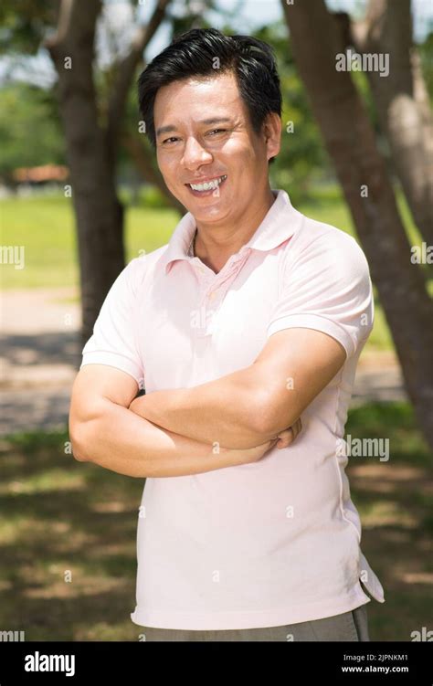 Portrait Of Happy Mature Vietnamese Man Smiling At Camera Stock Photo Alamy