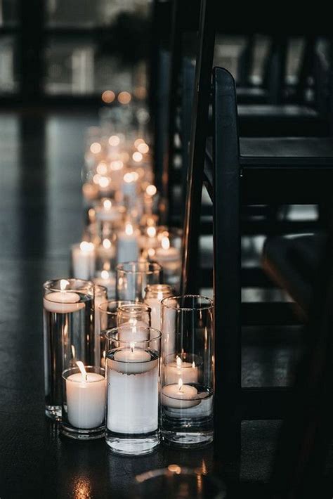 Many Lit Candles Are Lined Up On The Floor Next To Each Other In Glass