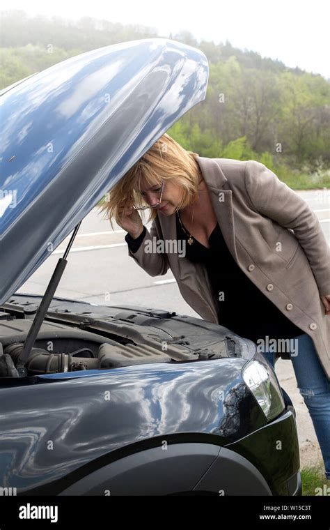 Accident And Breakdowns With Auto Concept Blonde Woman And Broken Down Car On Road Checking