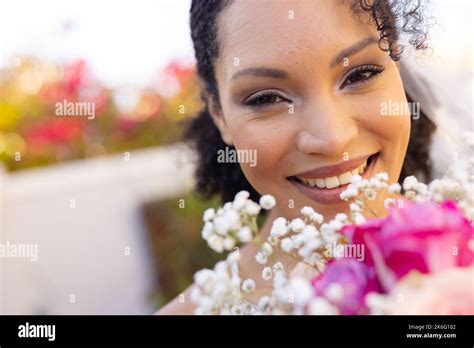 Portrait Of Happy African American Woman Wearing Veil And Holding