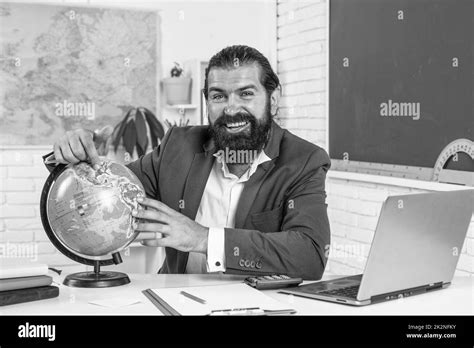 Mature Bearded Man Teacher In Costume Sit In School Classroom With Blackboard Geography Stock