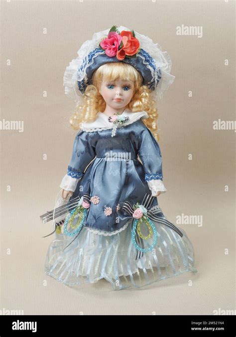 Vintage Porcelain Doll Baby Girl With Blue Eyes Blonde Curls Wearing A Blue Hat Decorated With