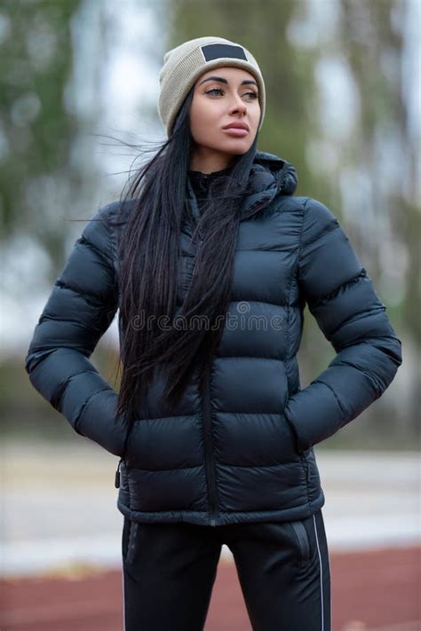 Beautiful Brunette Woman Posing At The Sport Stadium In Jacket And Hat Stock Photo Image Of