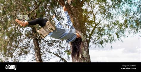 Lifestyle Latina Woman Swings On A Swing In A Tree Stock Photo Alamy