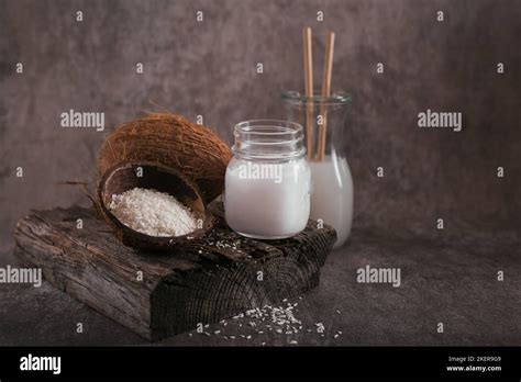 Bottle Of Coconut Vegan Milk Coco Oil Whole Coconut And Flakes On