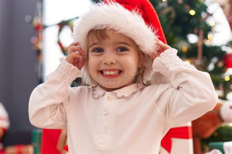 Adorable Blonde Girl Smiling Confident Standing By Christmas Tree At Home Stock Image Image Of