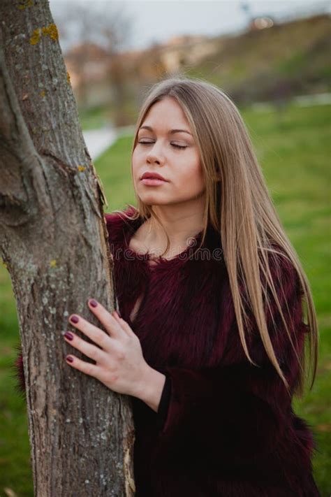 Portrait Blonde Girl Next To A Tree Trunk Stock Photo Image Of Cute Outdoors
