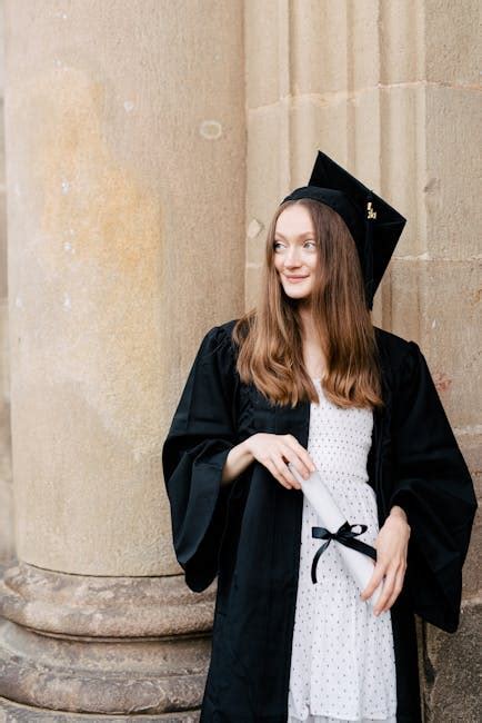 Person in Blue Vest Holding an Academic Cap · Free Stock Photo