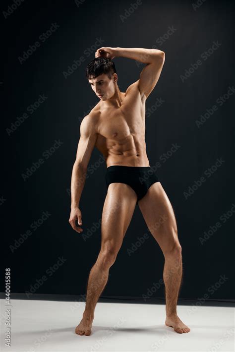 Man With A Pumped Up Naked Torso In Dark Panties Posing Stock Photo Adobe Stock