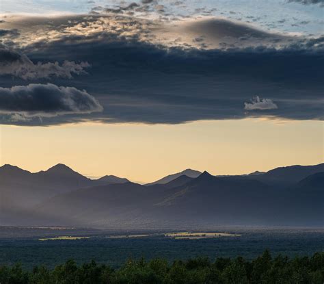 green coated hill  houses  stock photo