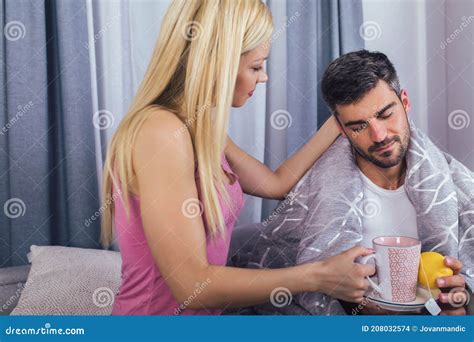 Woman Taking Care Of Her Sick Boyfriend At Home Stock Photo Image Of