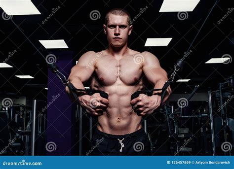 Brutal Strong Athletic Man Pumping Up Muscles Muscular Bodybuilder With Naked Sport Torso Doing