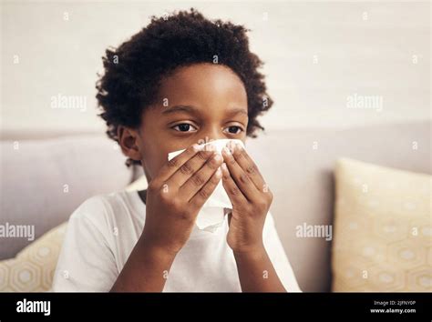 sick african american boy  afro blowing nose  tissue child