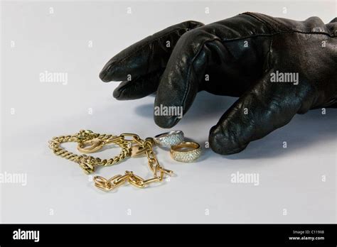 Thief With Gloved Hand Stealing Jewelry Stock Photo Alamy