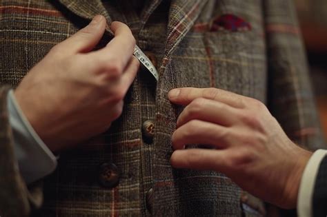 Premium Photo A Close Up Of A Person Tying A Tie