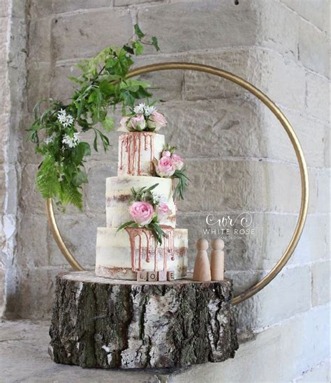 Three Tier Semi Naked Wedding Cake With Fresh Flowers And Rose Gold Drips