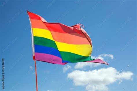 Rainbow Flag At A Gay Pride Parade With A Blue Sky Background Stock Photo Adobe Stock