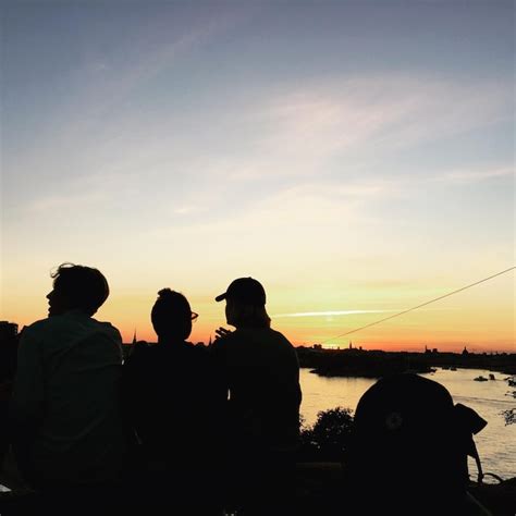 Premium Photo View Of Silhouette Tourist Sitting Next To River