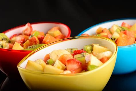 premium photo fruit salad  colorful bowls