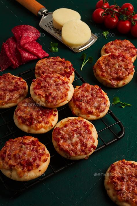 Mini Pizzas Salami With Mozzarella Cheese On The Table Top View No