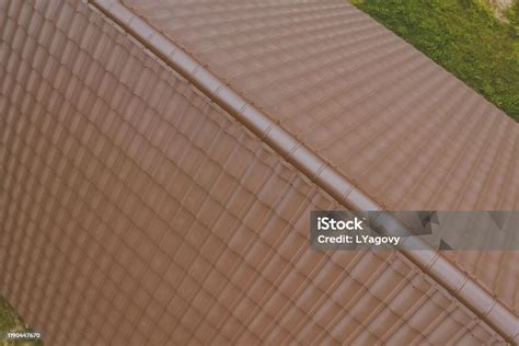 Brown Metal Tile On The Roof Of The House Corrugated Metal Roof Stock